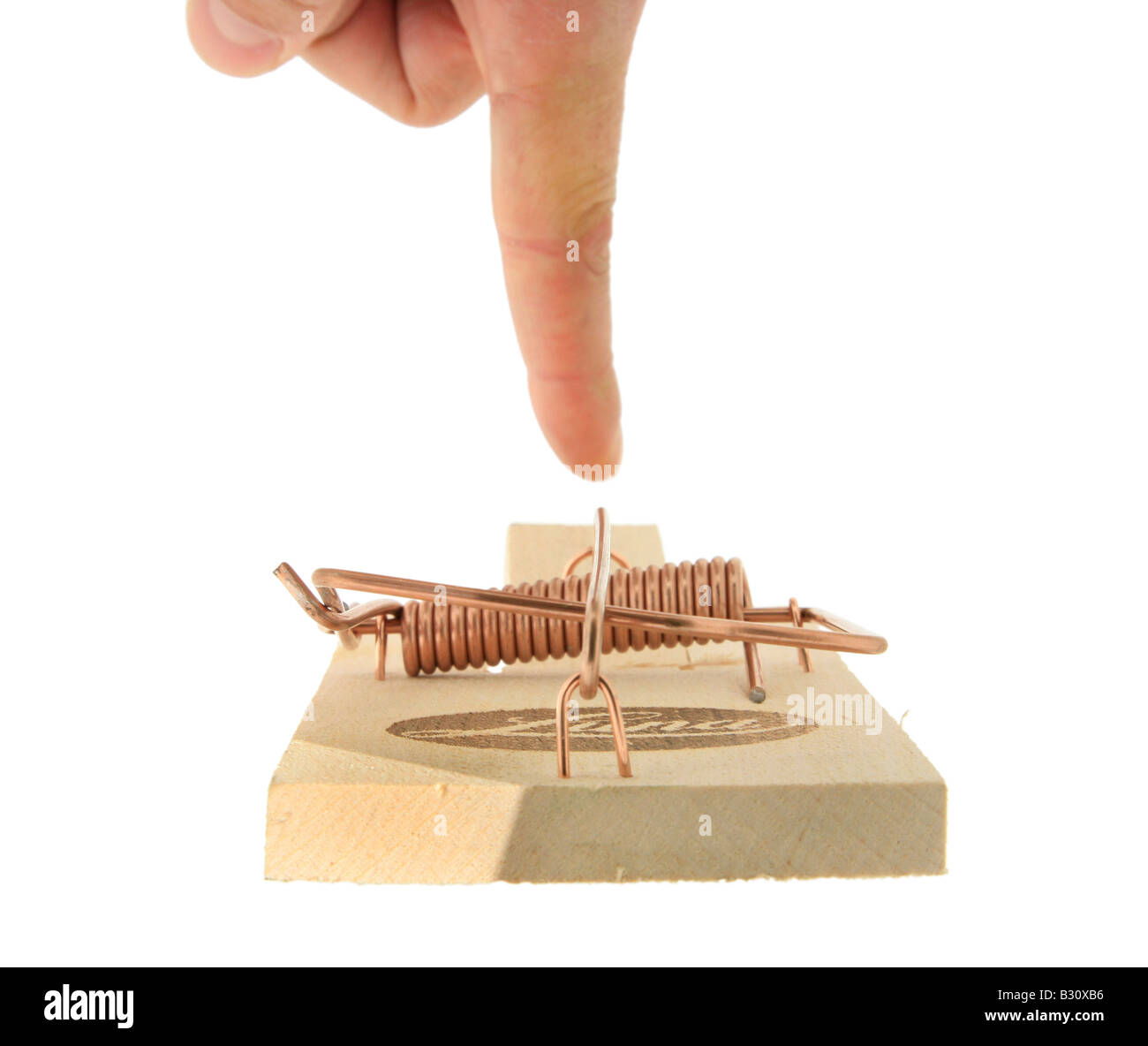 finger testing mousetrap Stock Photo
