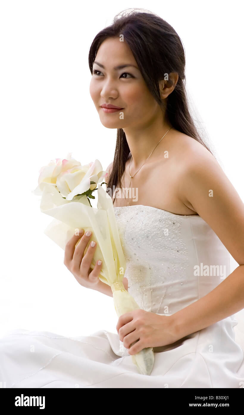 A beautiful young asian woman in a white wedding dress Stock Photo