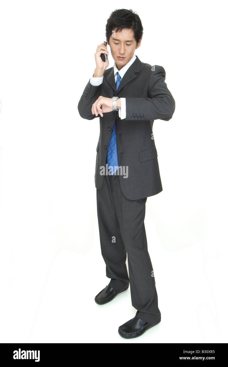 An asian businessman arranges a meeting by phone Stock Photo