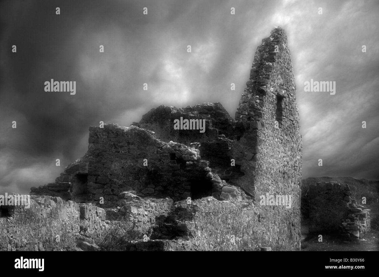 An eerie stormy sky behind an old ruined stone building Stock Photo