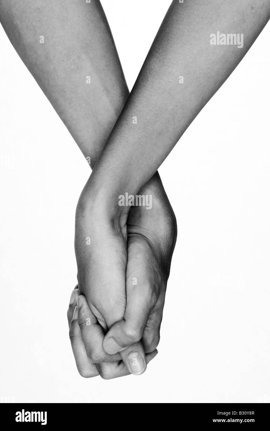 Two hands clasped together in monochrome Stock Photo
