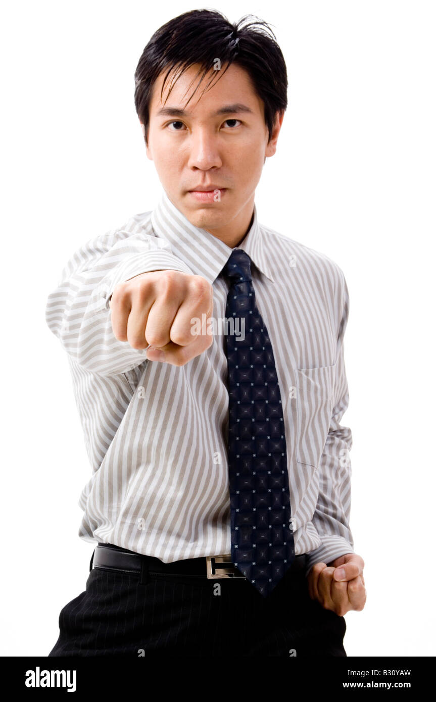 A young asian businessman does a karate punch Stock Photo Alamy