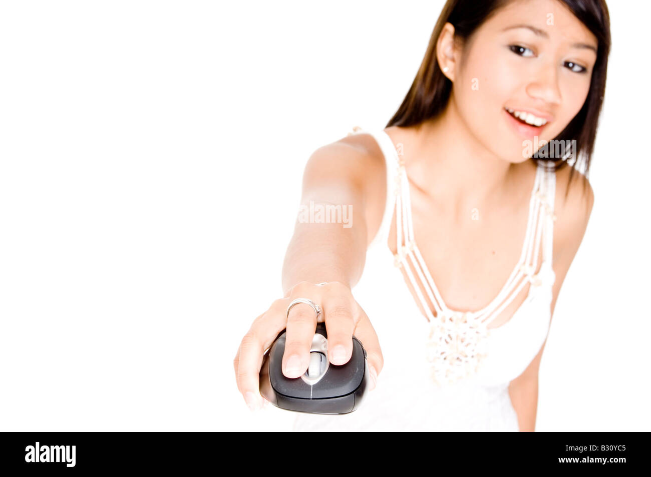 A pretty young asian woman uses a wireless computer mouse in free space