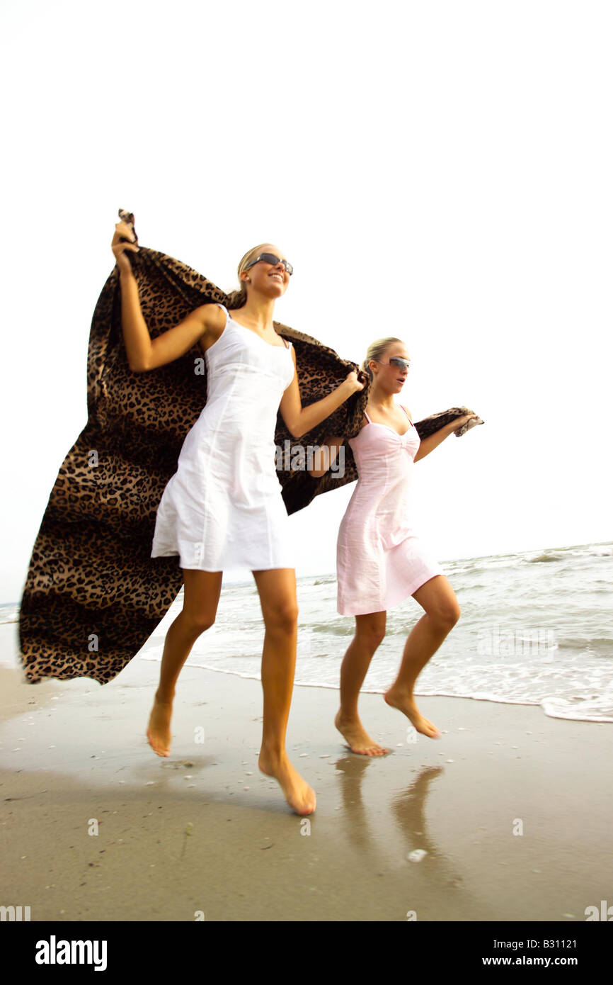Two young women on a beach hi-res stock photography and images - Alamy