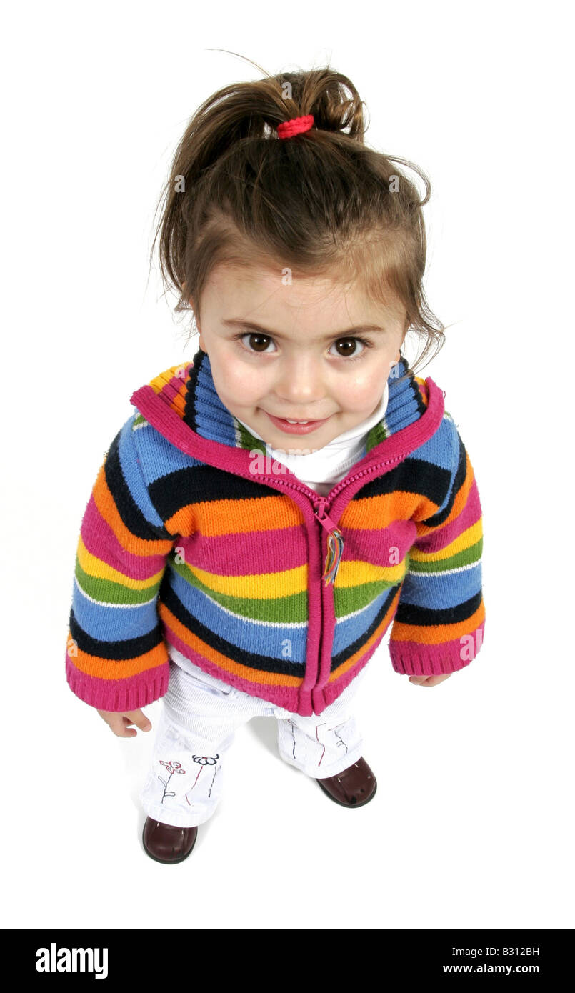 little girl with pigtail wearing colourful hooded cardigan Stock Photo