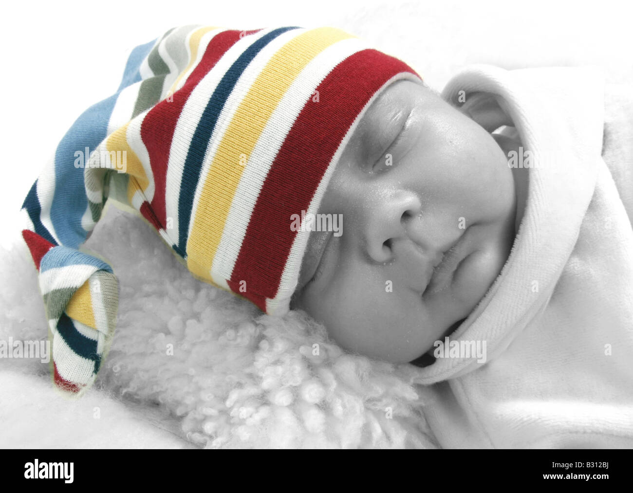 sleeping baby wearing curled jelly bag cap Stock Photo Alamy