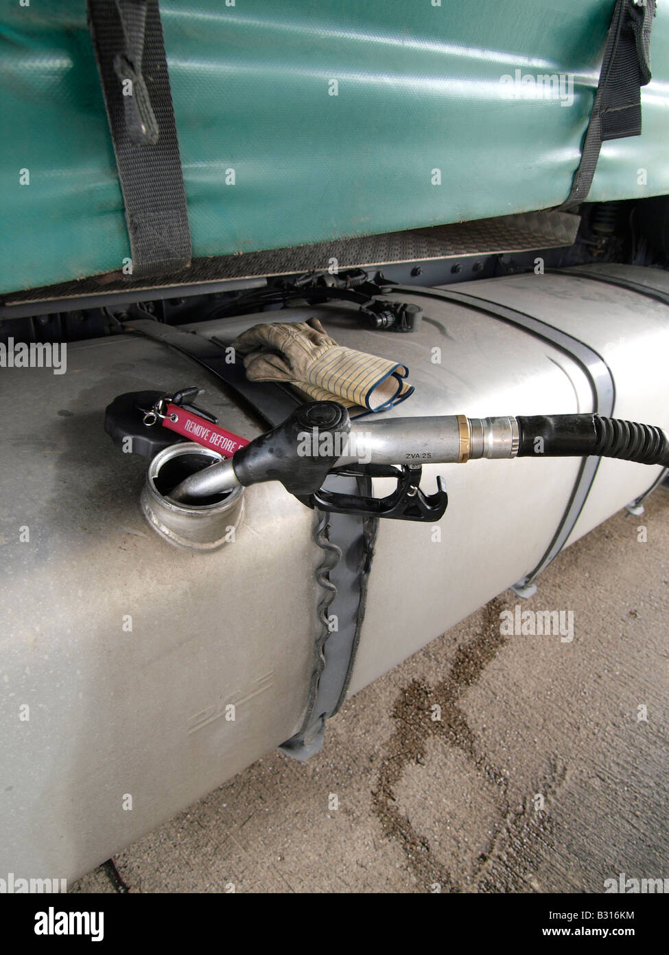Filling up the tank of a large truck with diesel fuel in Hazeldonk near the Dutch Belgian border nobody Stock Photo