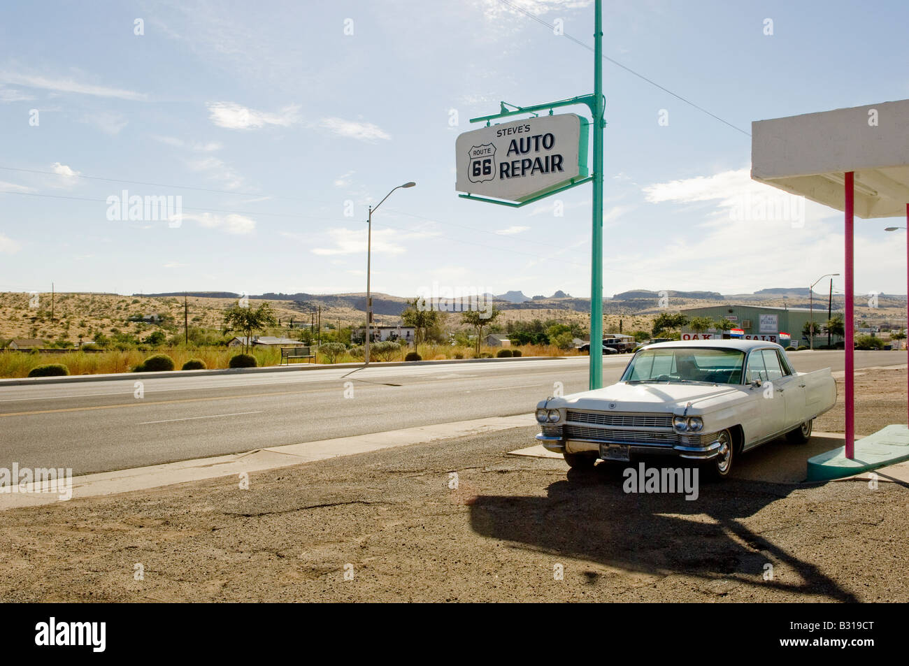 Landscape format colour picture of a white car parked at an Auto Repair