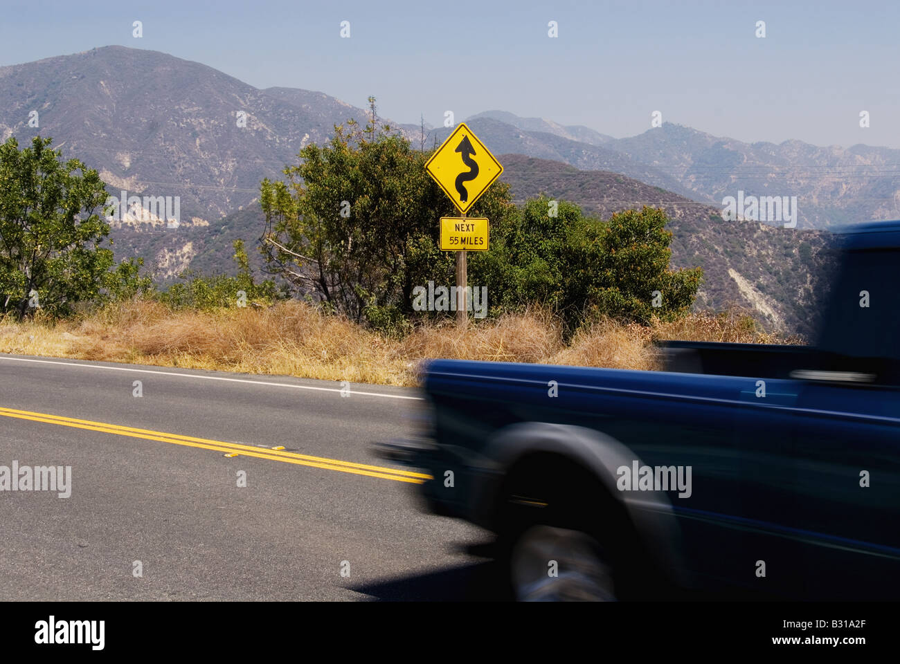 Curve ahead sign on street Stock Photo