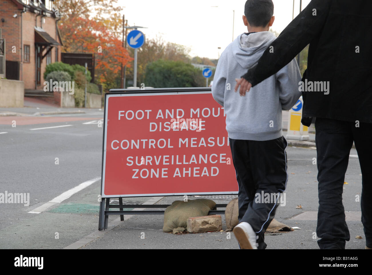 A sign in a residential road saying 'Foot and Mouth disease control