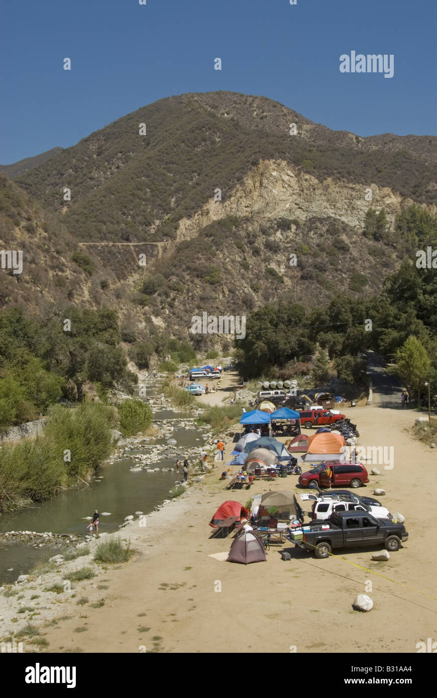 Campers along river Stock Photo - Alamy