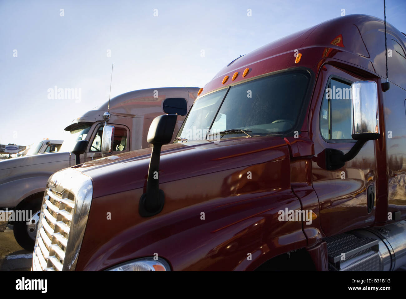 Side view of trucks parked at truckstop Stock Photo