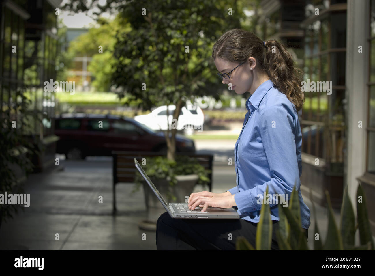 Young woman working on laptop Stock Photo - Alamy