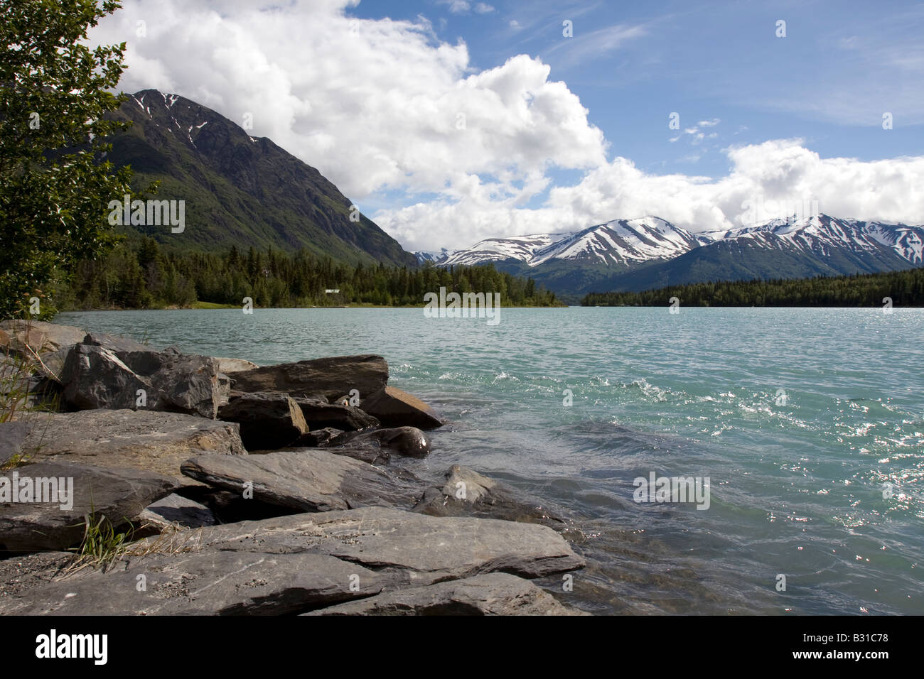 Lake surrounded by snow covered mountains Stock Photo