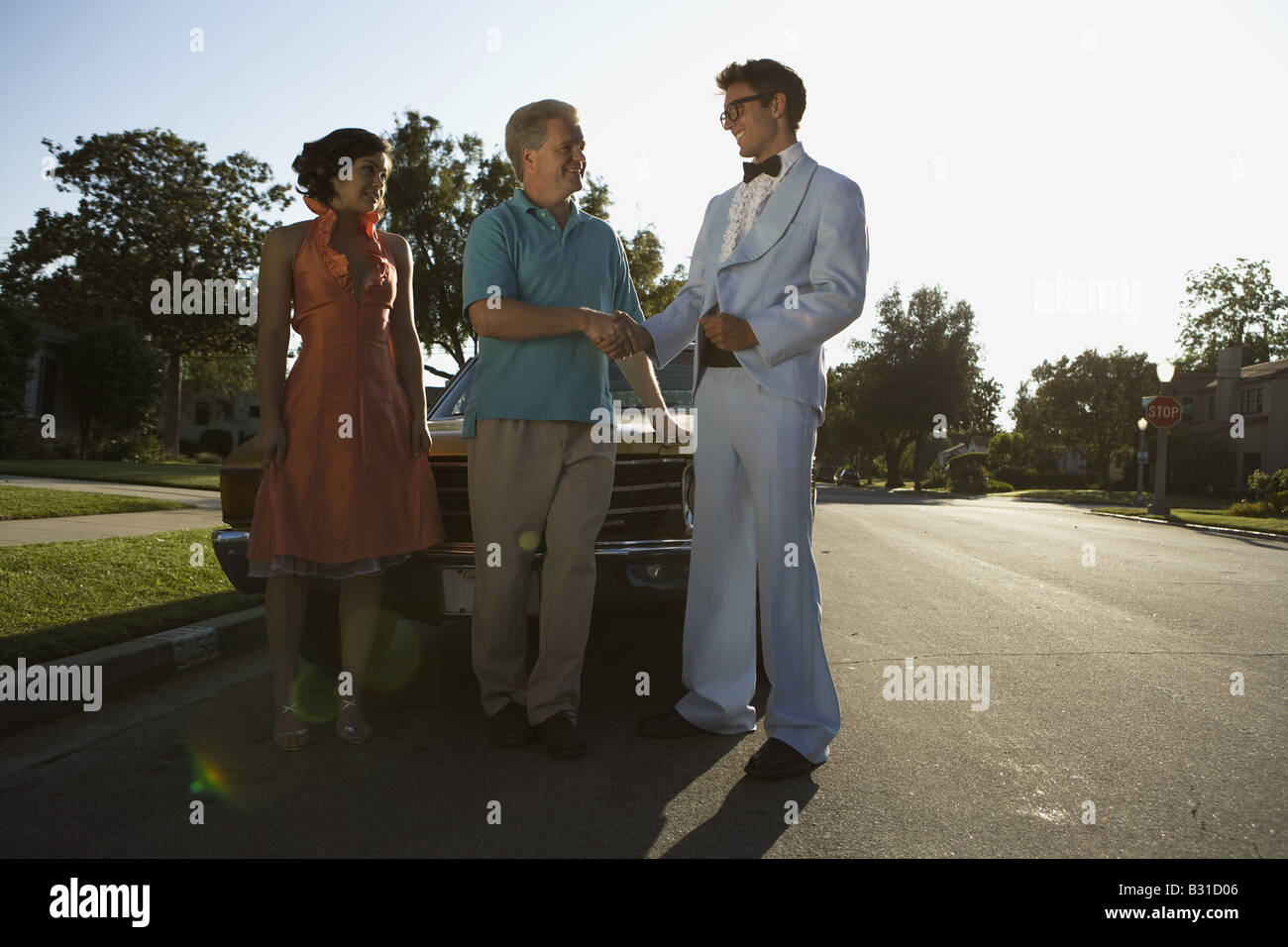 Fatherto Prom Father shaking hands with daughters prom date Stock Photo - Alamy
