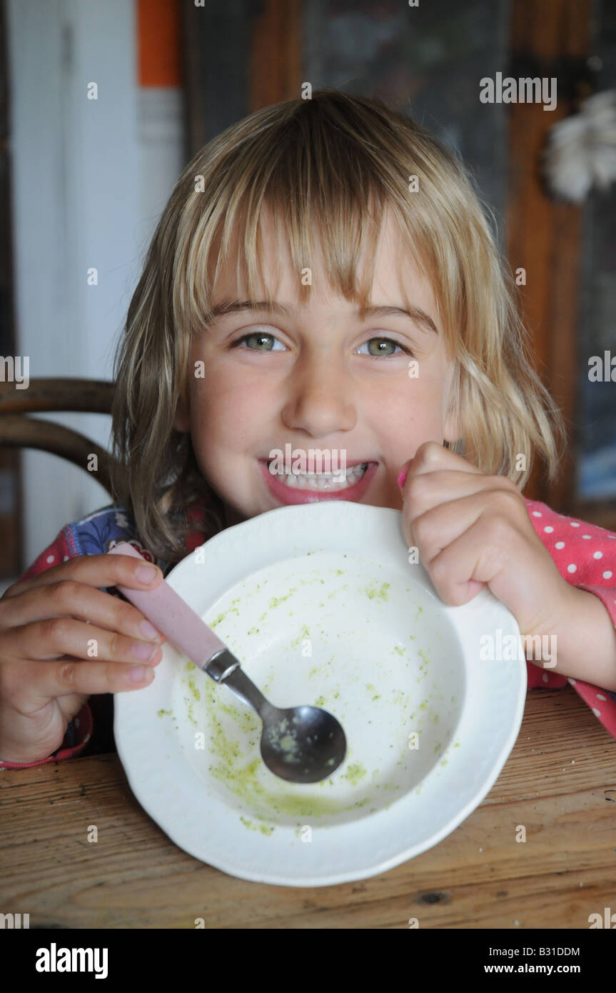 A child shows of her empty bowl Stock Photo