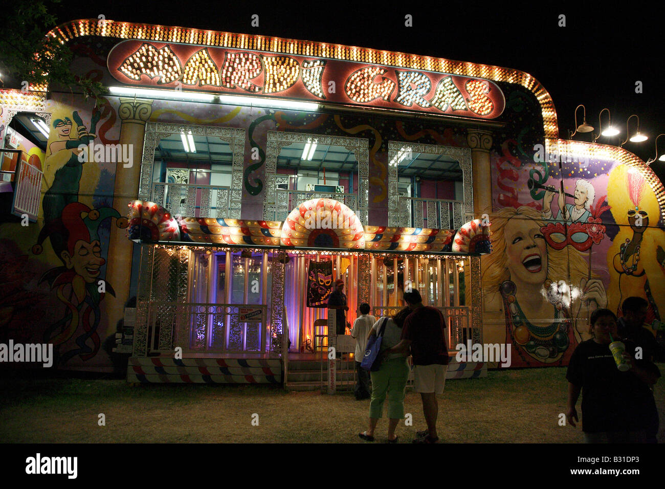Mardi Gras funfair house and hall of mirrors Lit up at night like a pinball machine. Stock Photo
