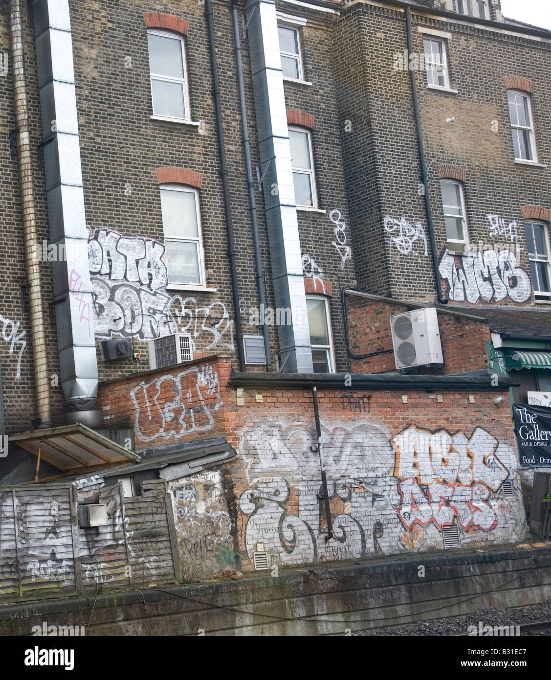 Graffiti found on brick building against rail track of underground in North London Stock Photo
