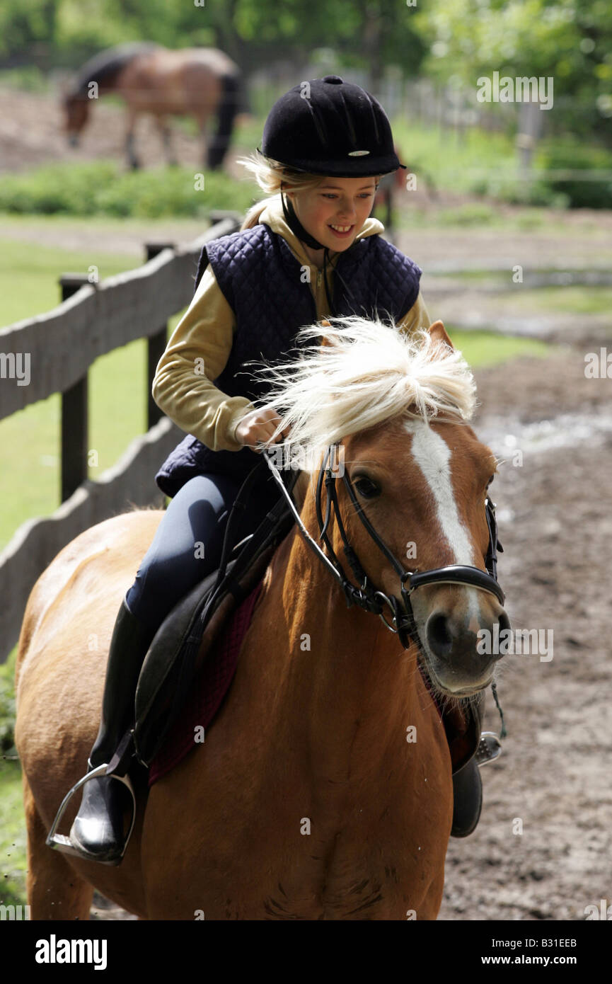 Young girl riding a horse Stock Photo Alamy