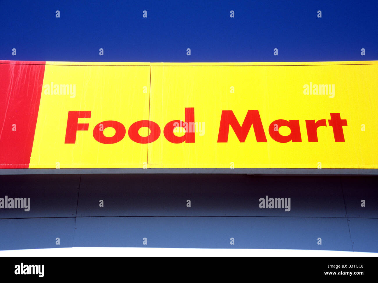 Colorful Food Mart sign against clear blue sky Stock Photo Alamy