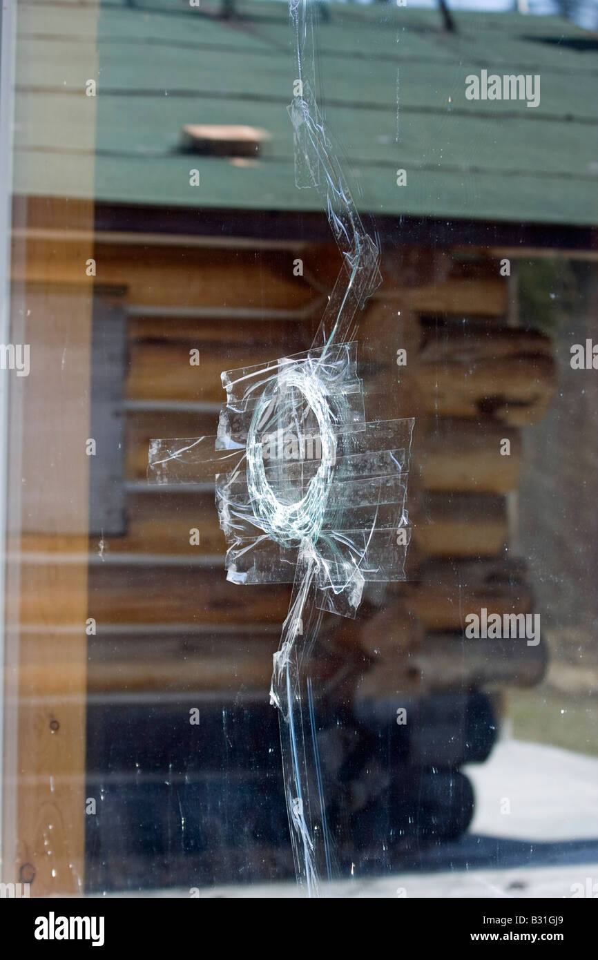 22 rifle bullet makes a hole in window. Stock Photo