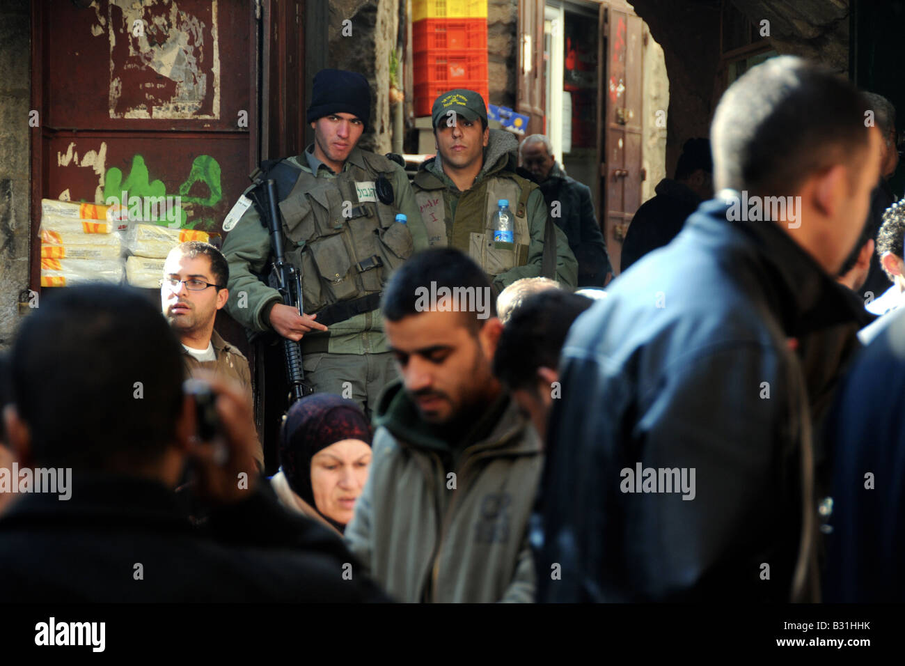 Two Israeli soldiers patrolling an area of the Arab market in Jerusalem's Old City. Stock Photo