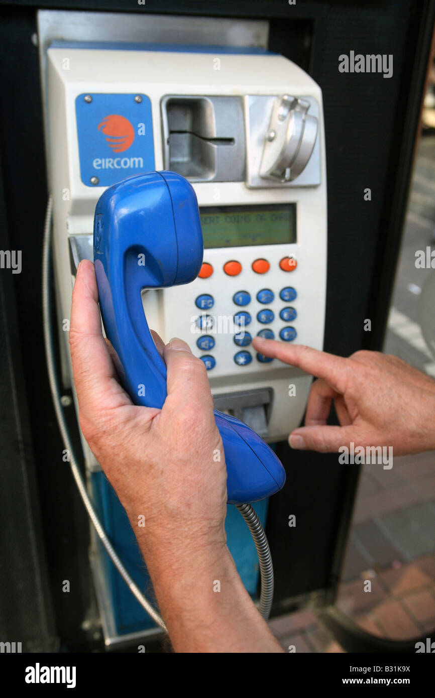 Man dialing a public telephone, Dublin, Ireland Stock Photo Alamy