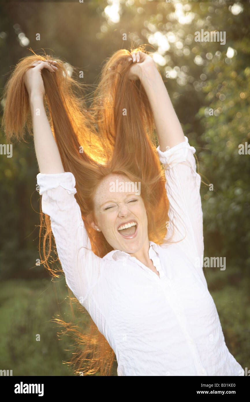young woman with red hair posing Stock Photo - Alamy