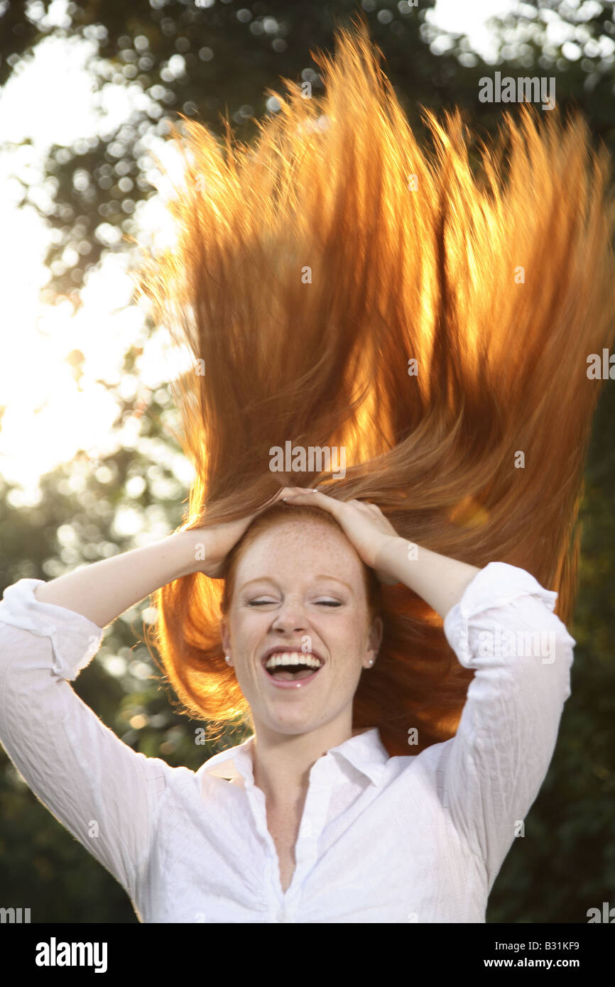 young woman with red hair posing Stock Photo - Alamy