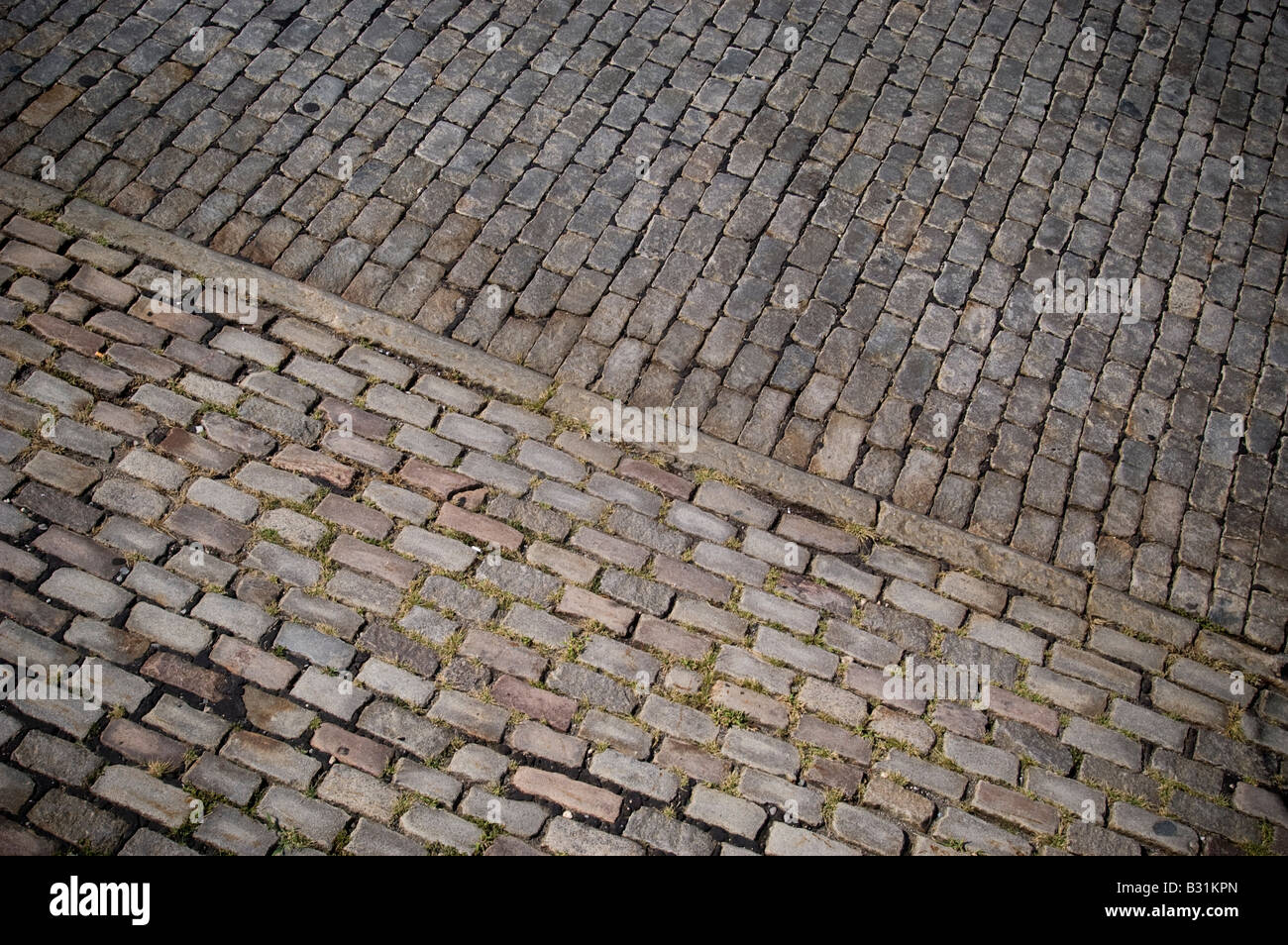 A detail of a street in Lower Manhattan in New York paved with Belgian Blocks Stock Photo