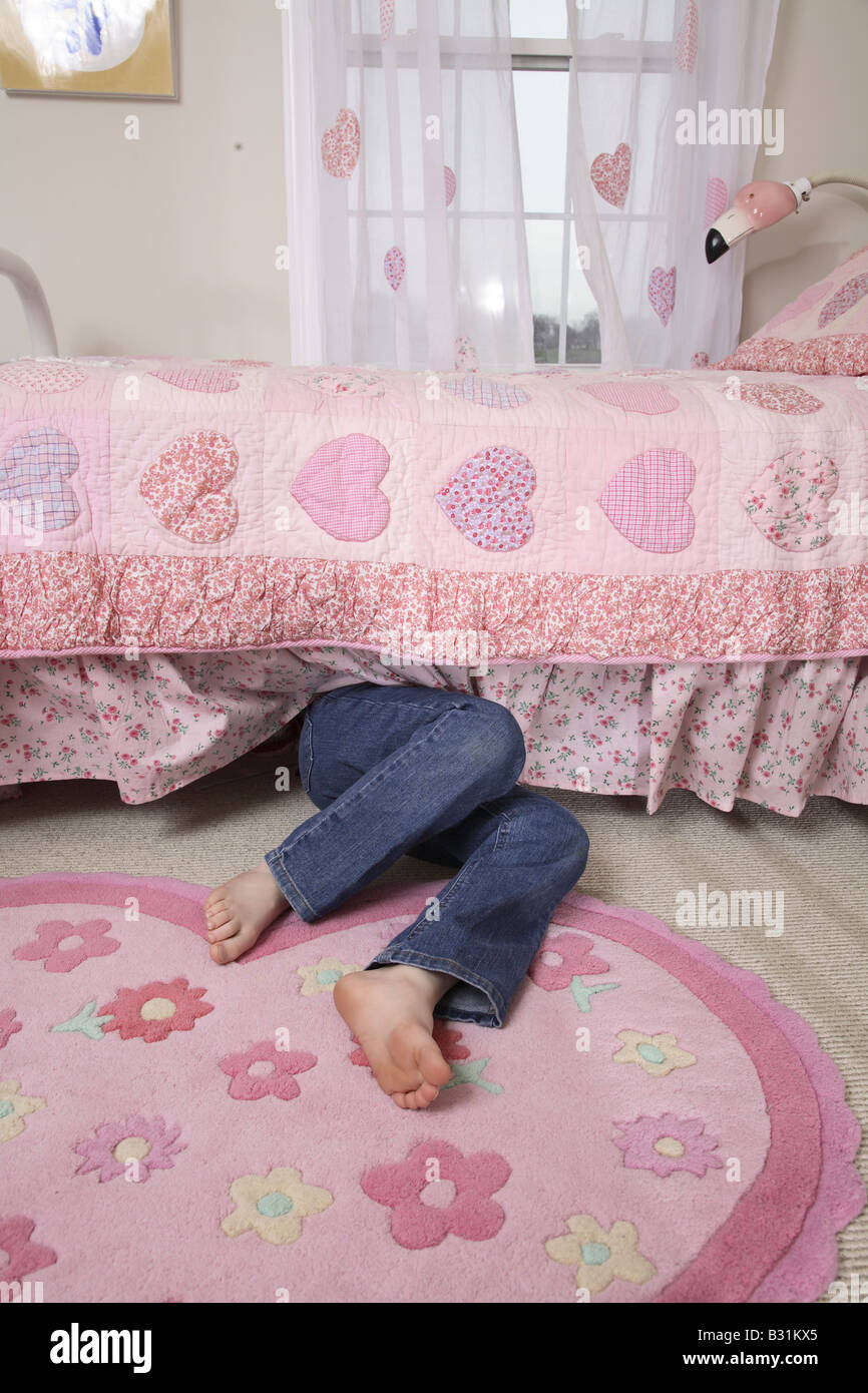young girl under bed Stock Photo Alamy