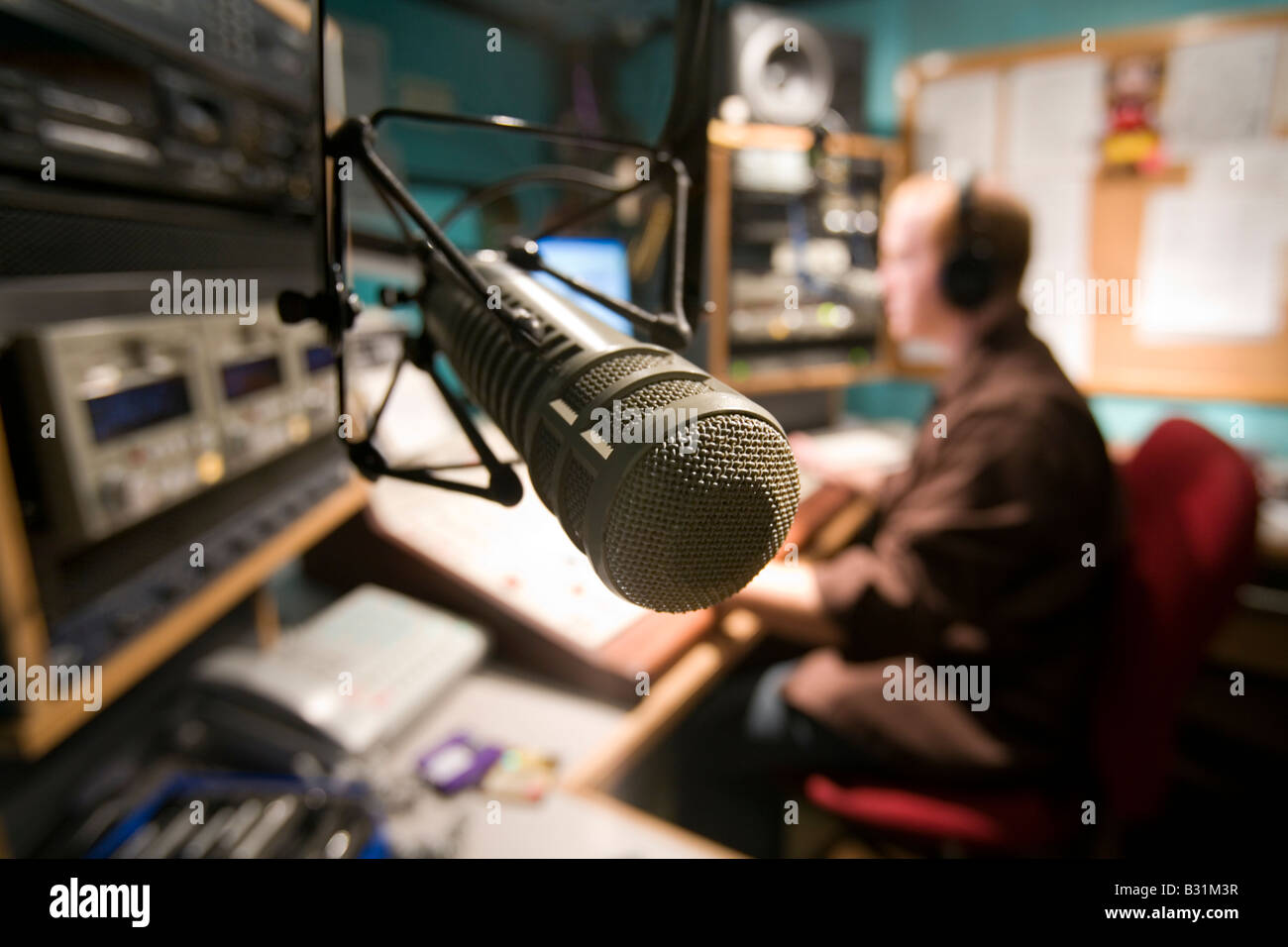 A Radio DJ hosts a radio program from his studio Stock Photo Alamy