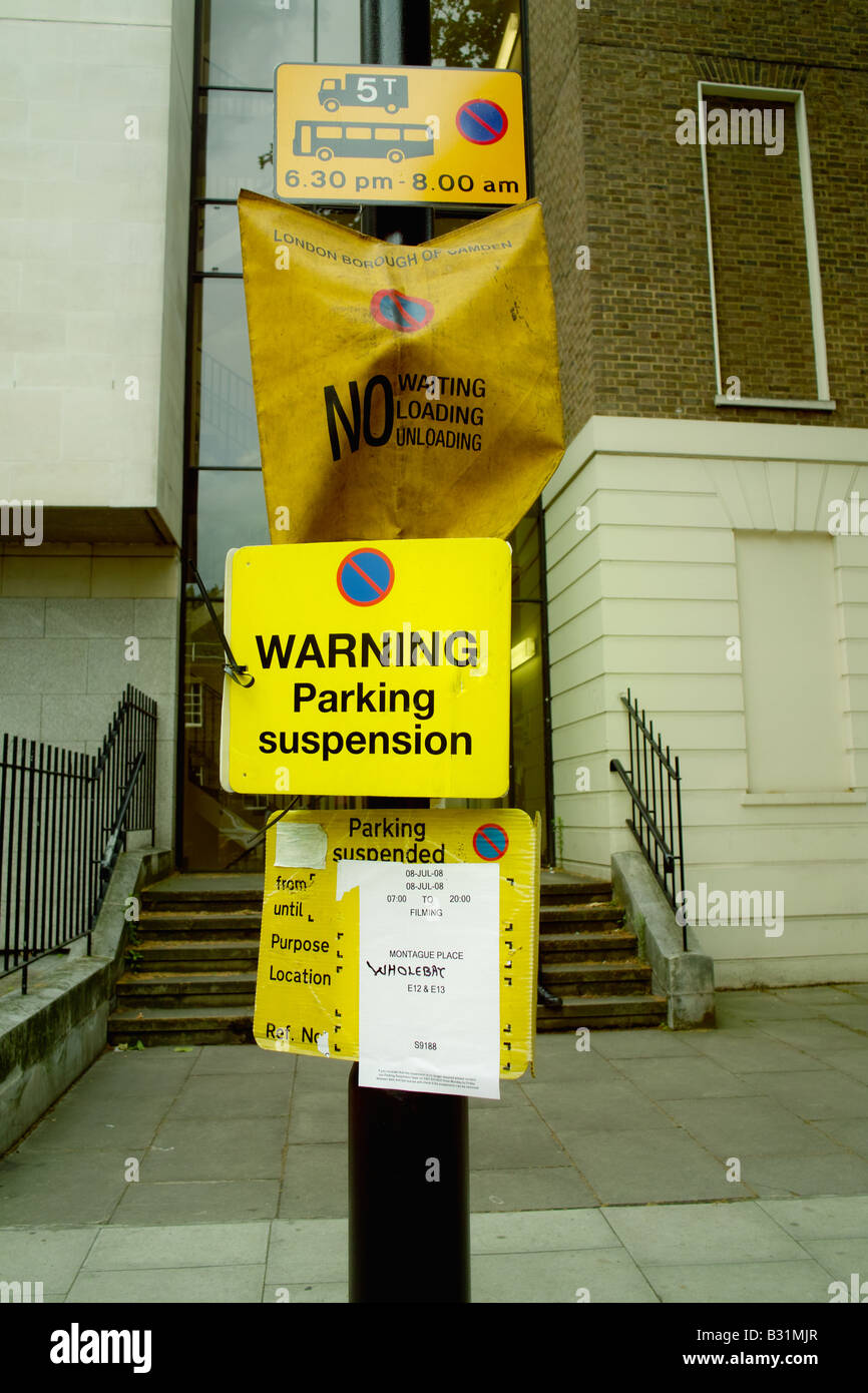 Suspended parking bays No parking suspension warning signs on lampost