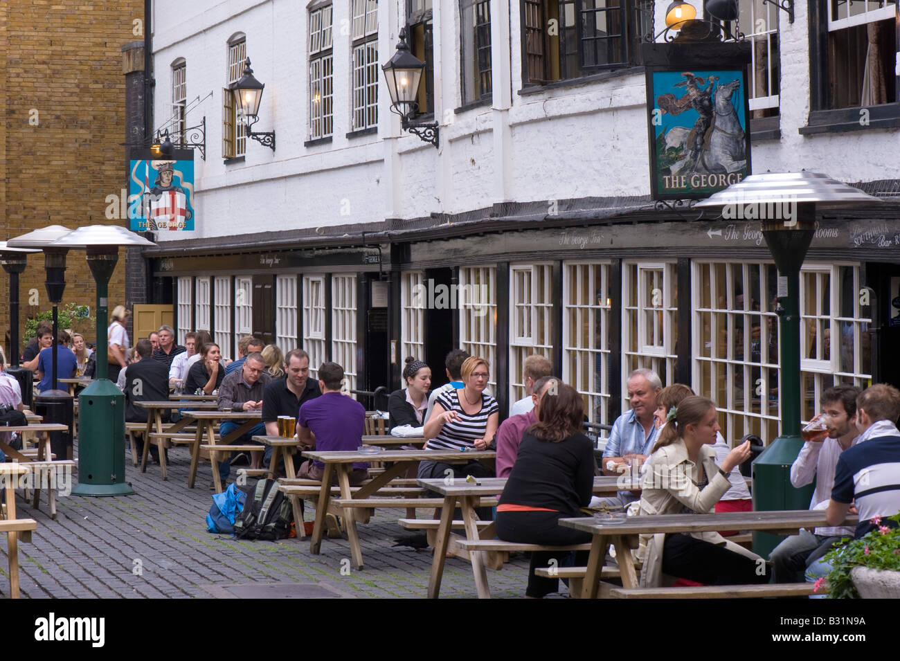 People enjoy drinking wine and beer at The George Pub in SE1 London United Kingdom Stock Photo