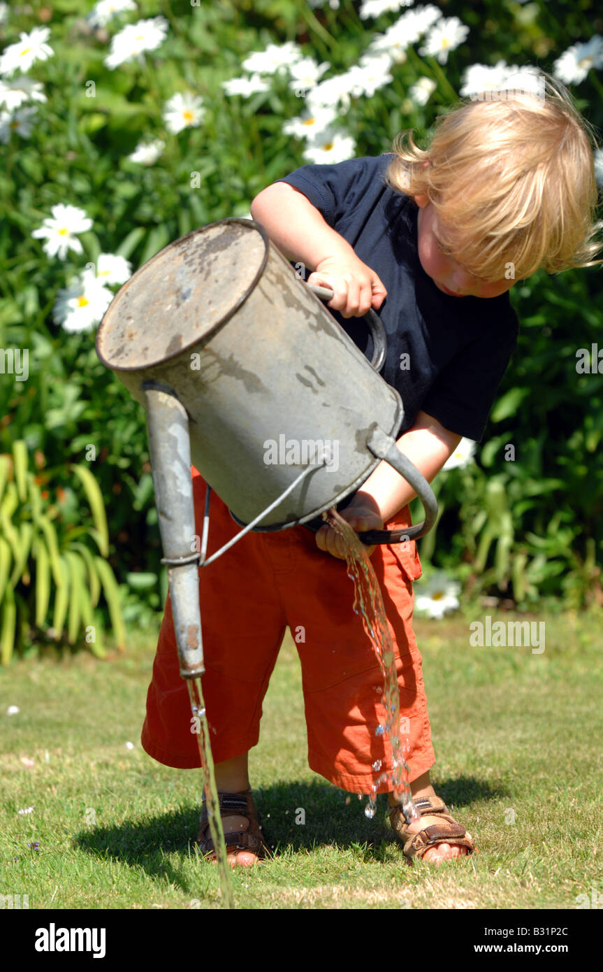 Child watering the garden Stock Photo