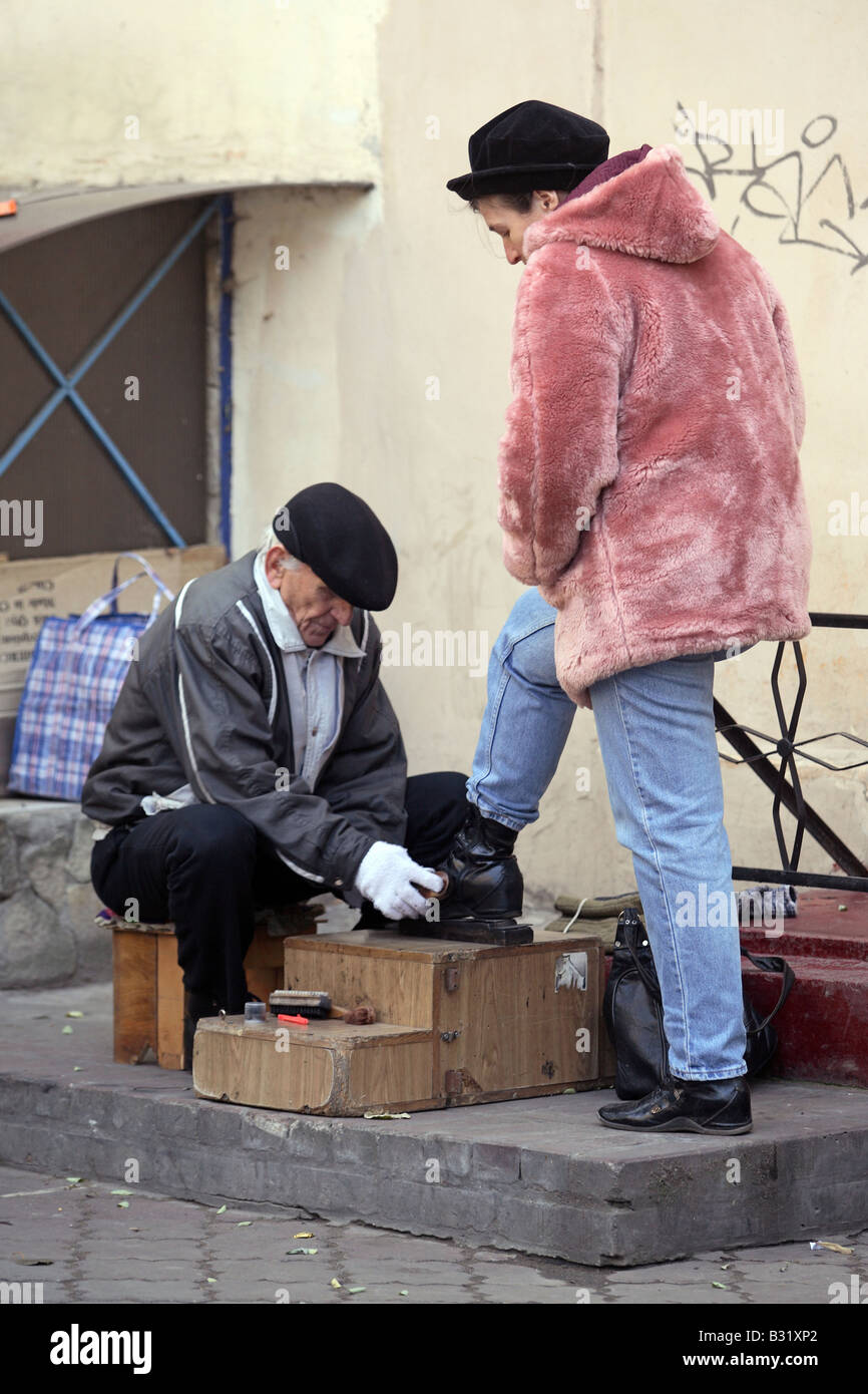 A shoeshiner brushing shoes, Odessa, Ukraine Stock Photo