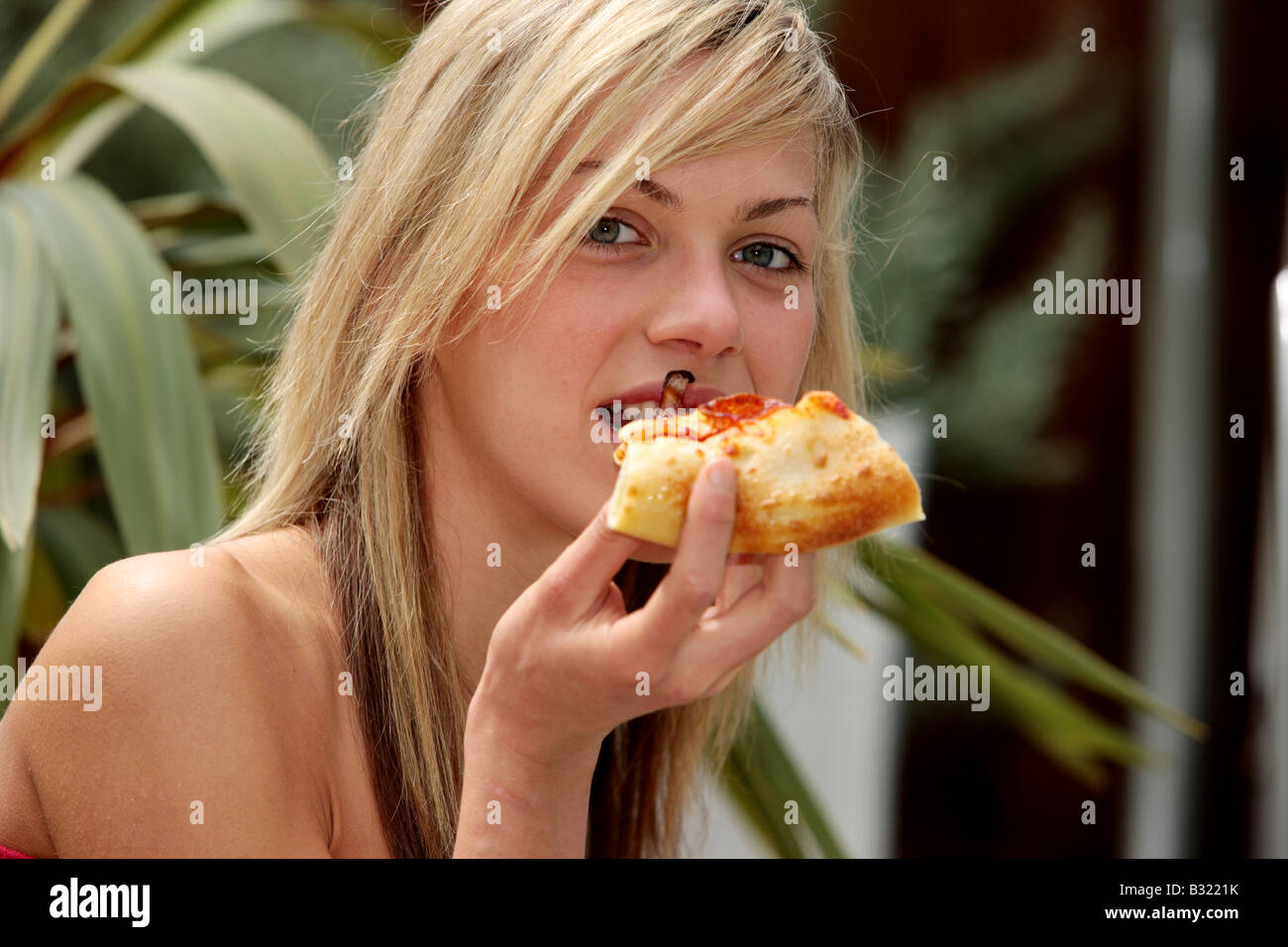 Young Woman Eating Pizza Model Released Stock Photo