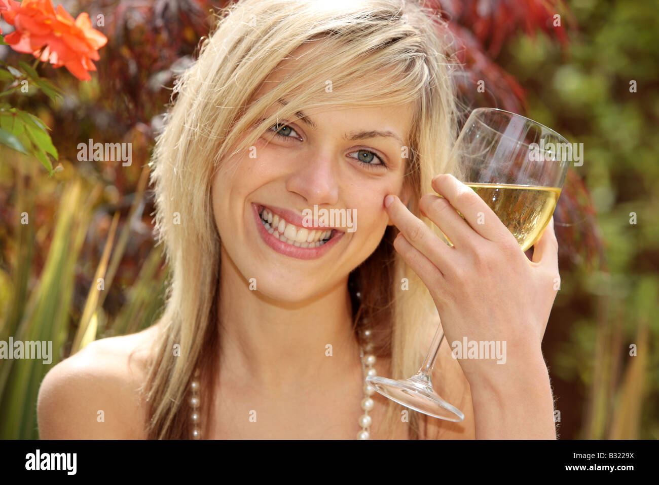 Young Woman Holding Glass of Wine Model Released Stock Photo - Alamy