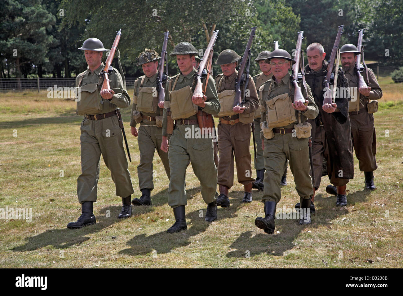 Home Guard soldiers marching with rifles on 1940s re-enactment Stock Photo