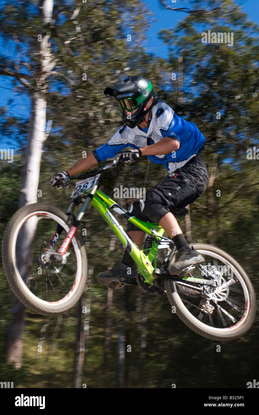 Downhill Mountain bike race extreme jump Stock Photo Alamy