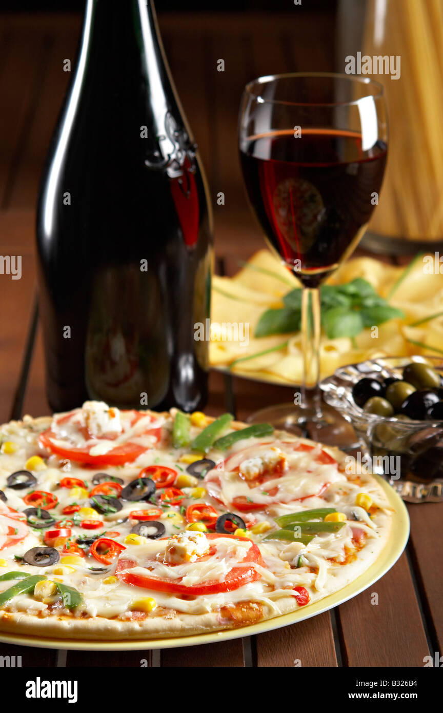 still life with red wine and pizza on the table Stock Photo