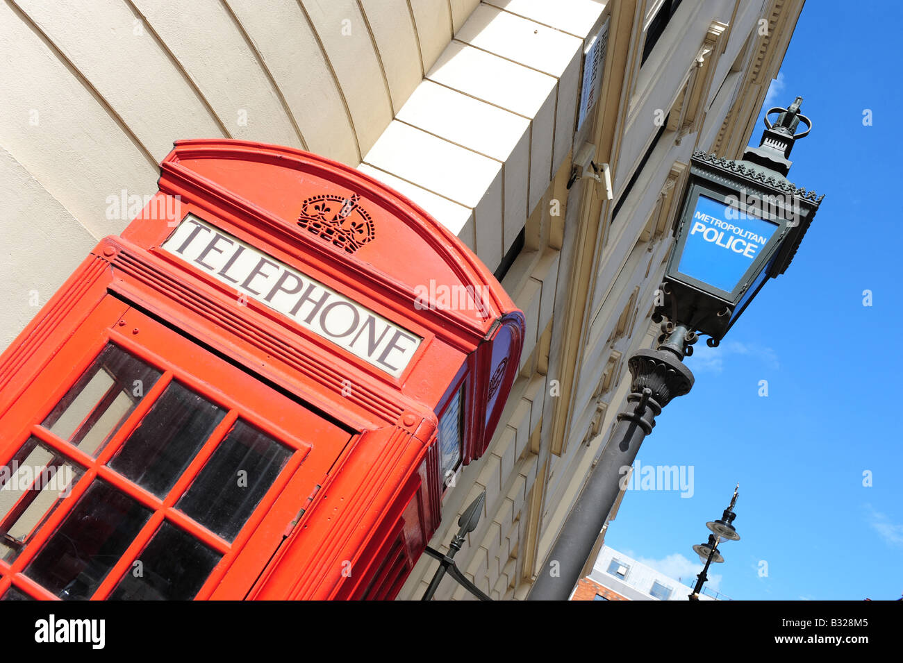 red telephone box and police sign london england call box communications help tourists law post lamp post Stock Photo