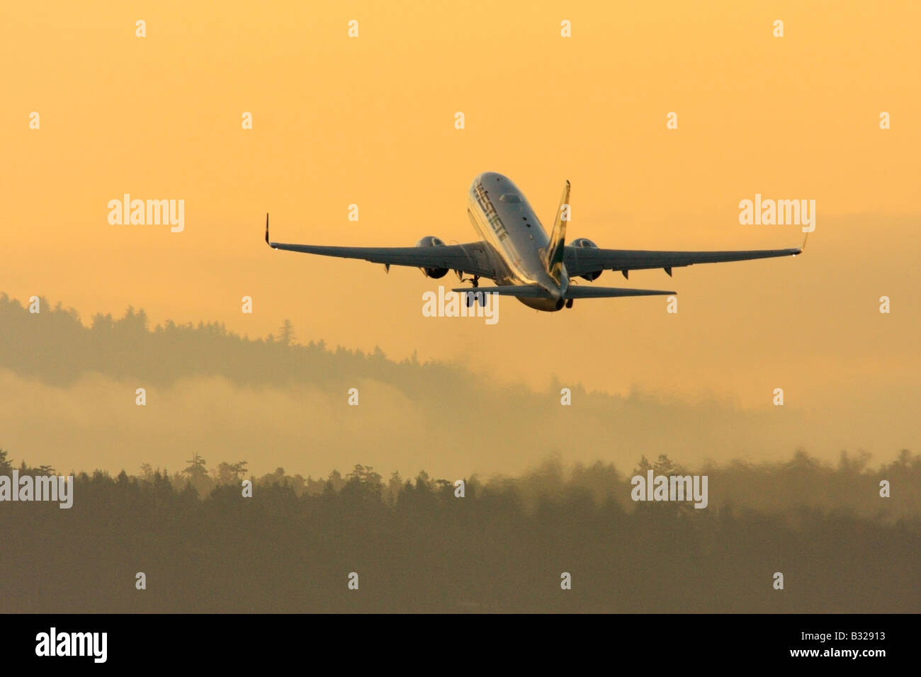 Boeing 737 700 airliner lifting off in early morning Victoria British Coolumbia Canada Stock Photo
