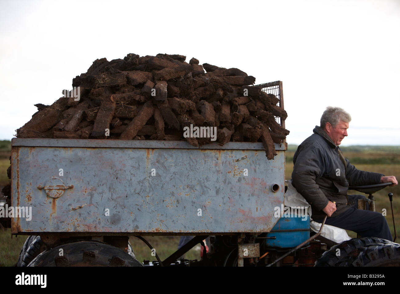 farmer bringing home the turf peat fuel collection on home made transporter in easkey county sligo republic of ireland Stock Photo