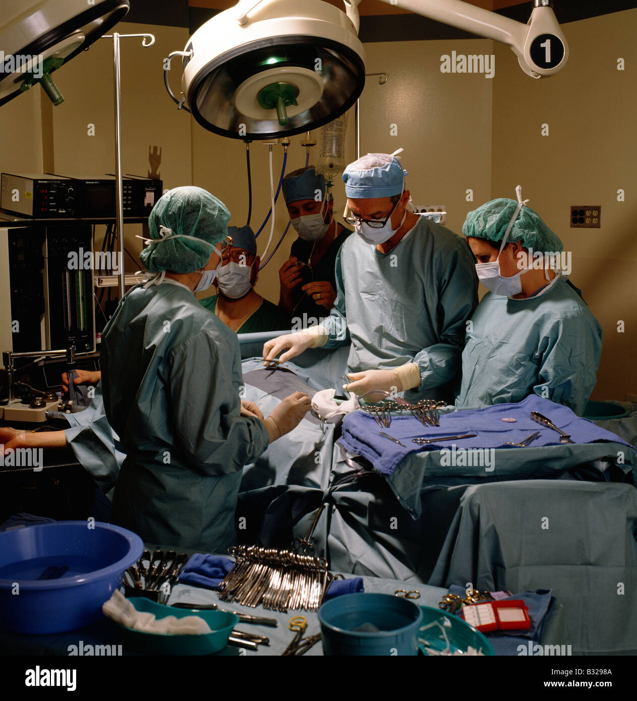 Surgeons, nurse and staff in an operating room in a hospital Stock