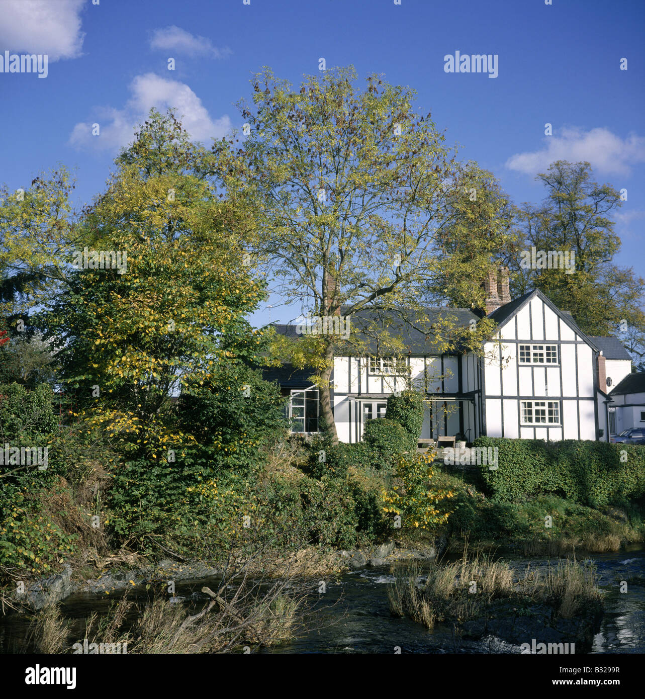 Black and white house beside the River Rhiw BERRIEW POWYS WALES Stock
