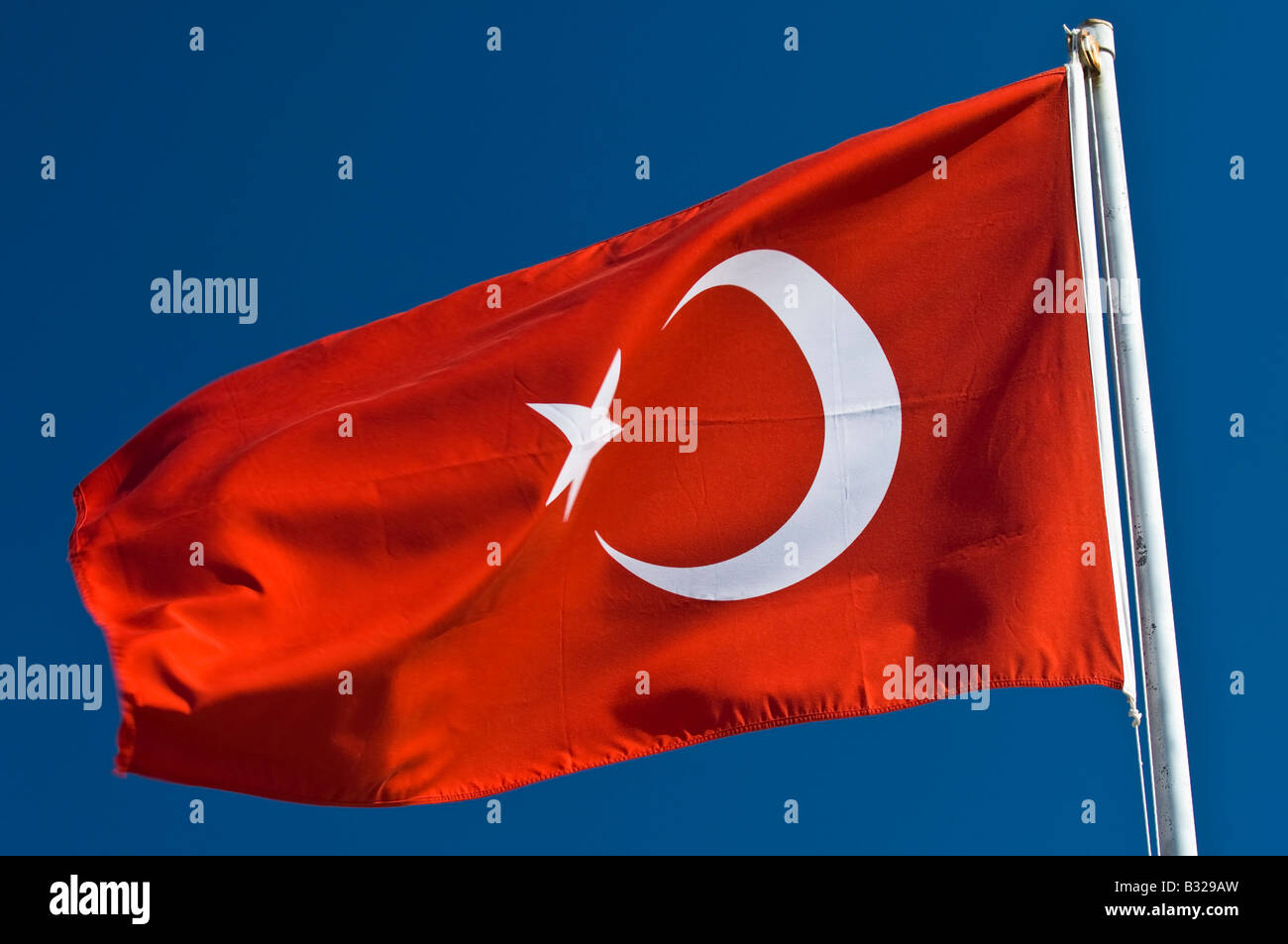 Turkish National flag flying above the Turtle Beach Mugla Turkey Stock Photo