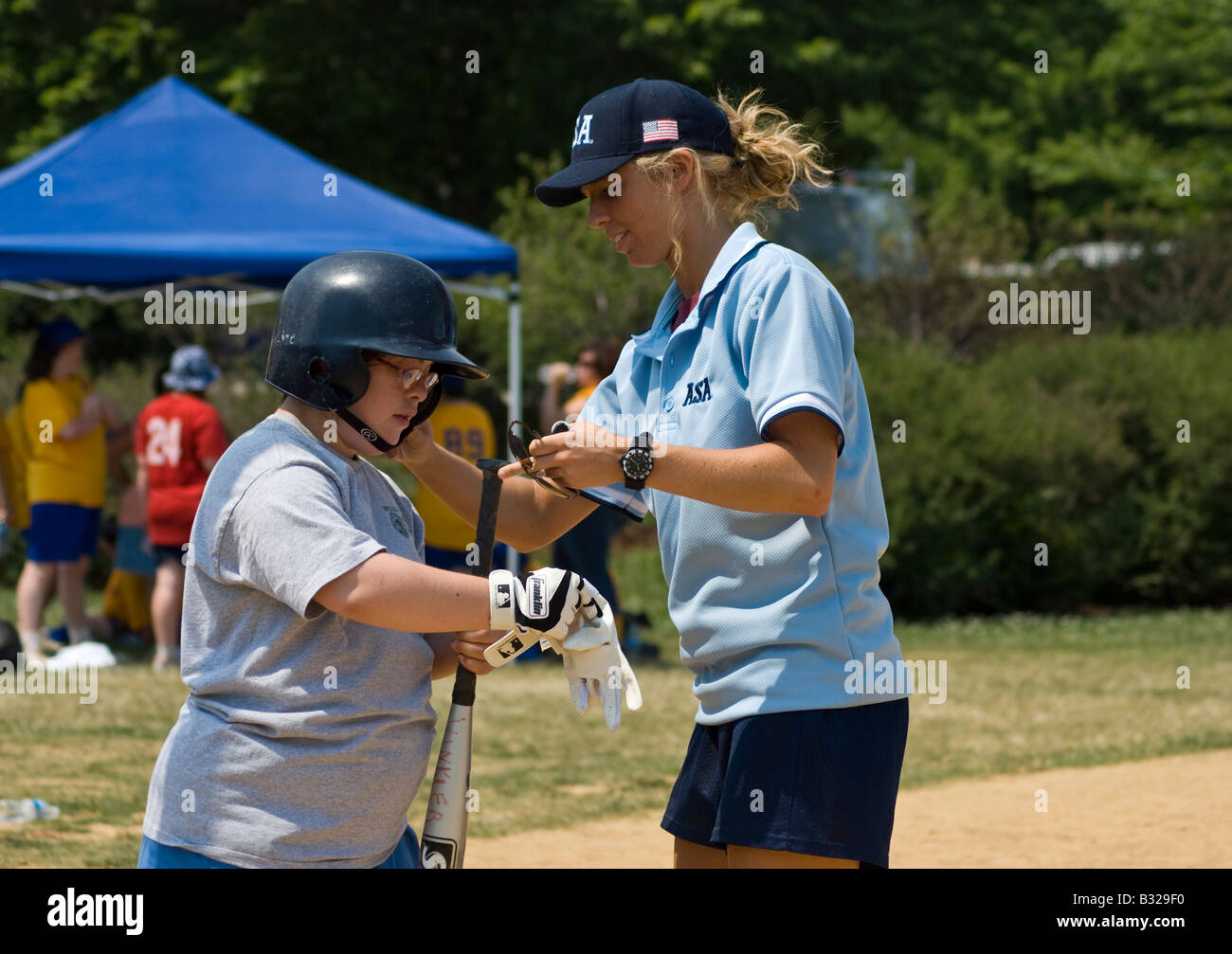 Referee helping a Special Olympics athlete put on her protective gear