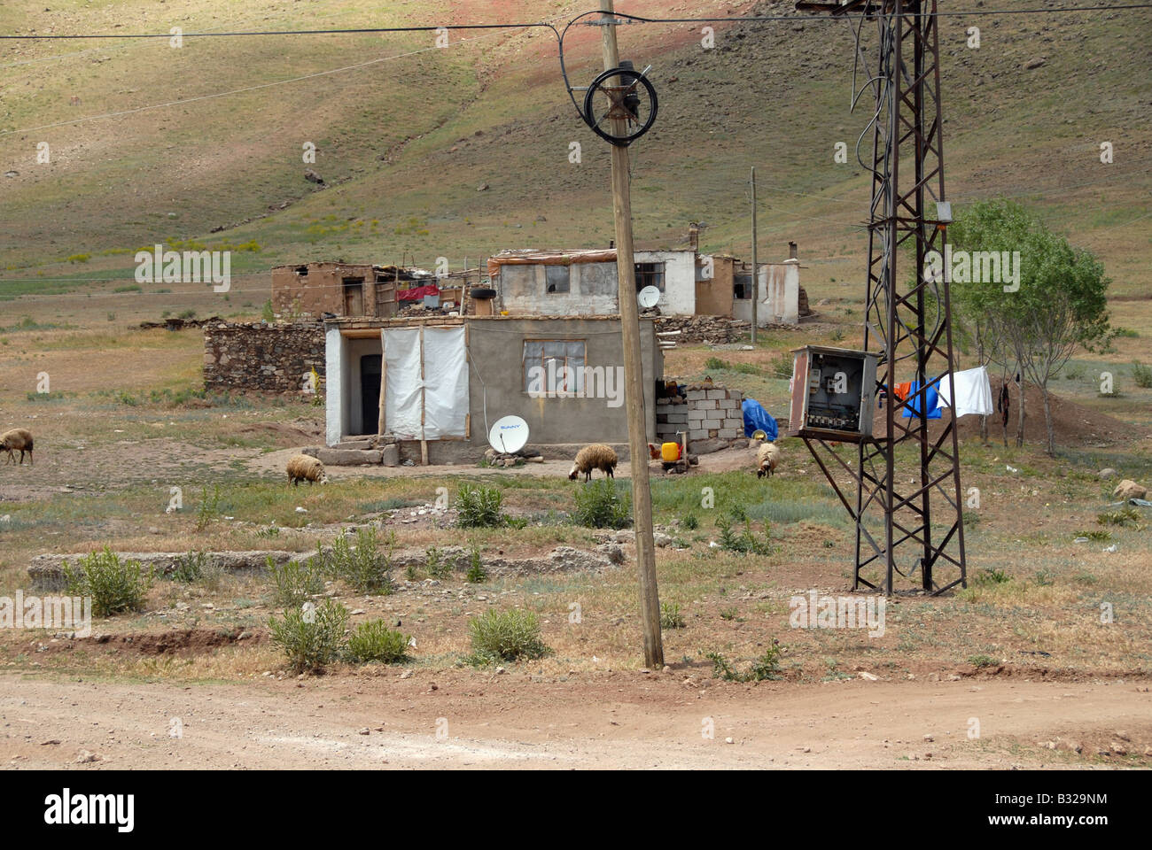 A Kurdish house in East Turkey. There is an open electricity cabinet in the foreground. Stock Photo