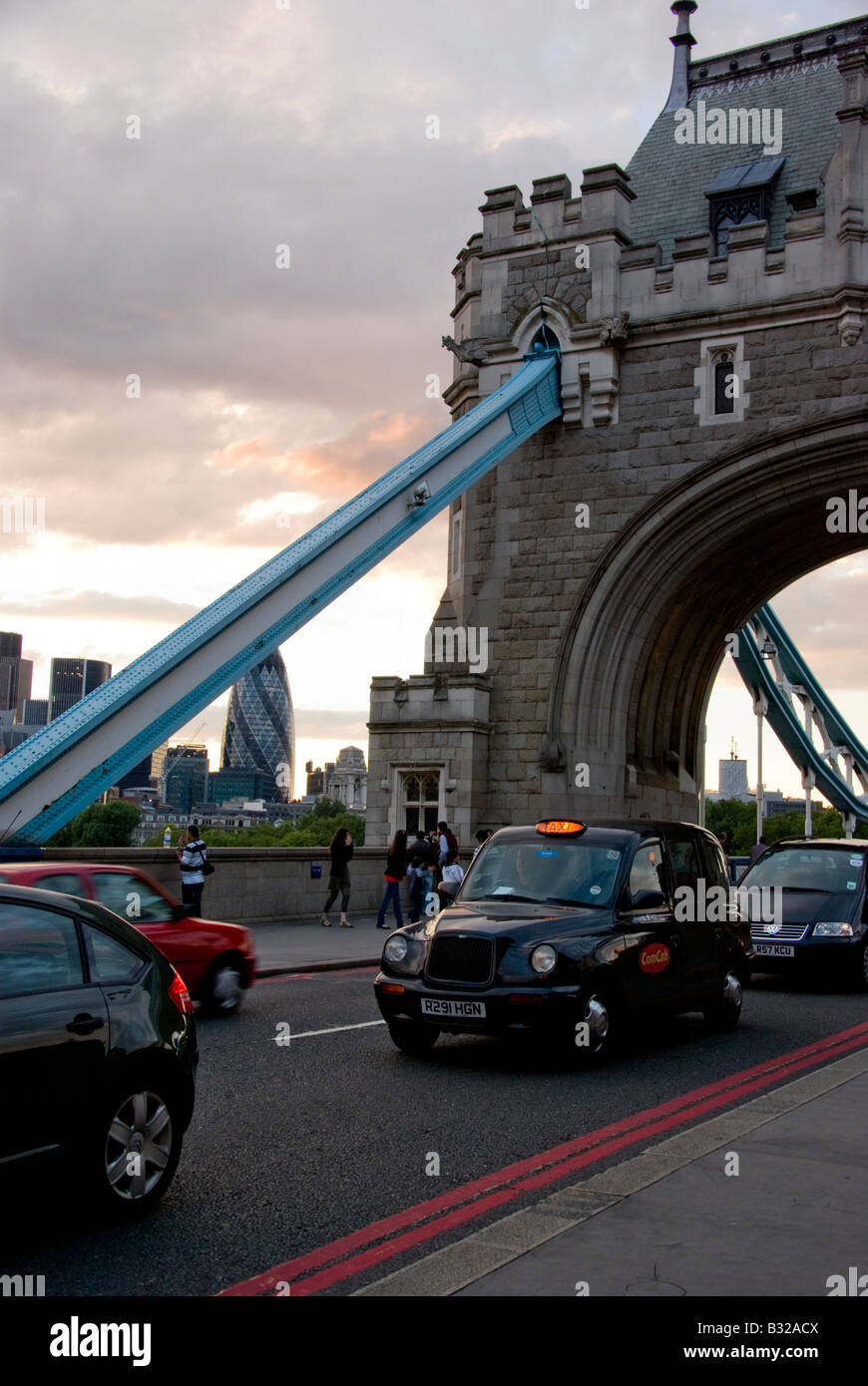 Cars crossing the Tower bridge near sunset Stock Photo
